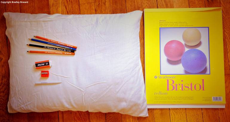 Photograph of buckwheat pillow with vellum pad and art supplies